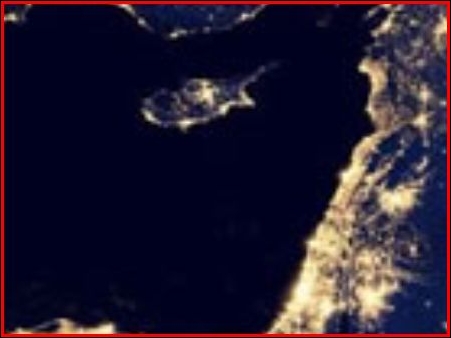 Η Κύπρος βράδυ, σε λήψη από δορυφόρο, οι φωτισμένες περιοχές είναι η Λευκωσία, ελεύθερη περιοχή Αμμοχώστου, Λάρνακα, Λεμεσός και Πάφος.